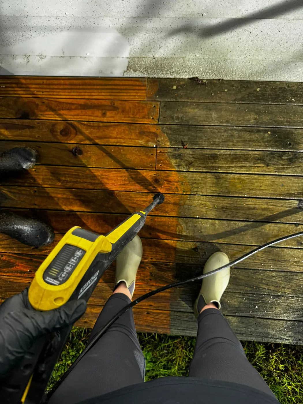 Timber deck being pressure washed