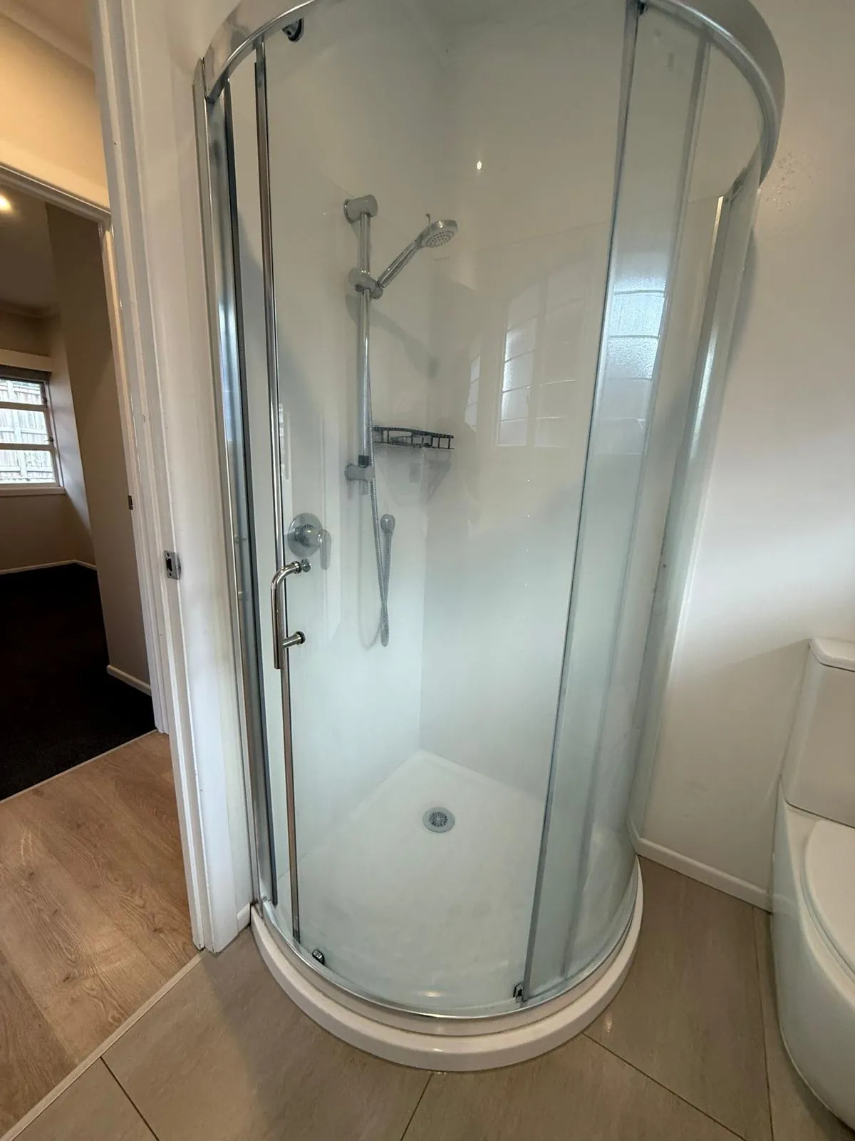 Bathroom cleaning before after Auckland — shower glass restored to crystal clear