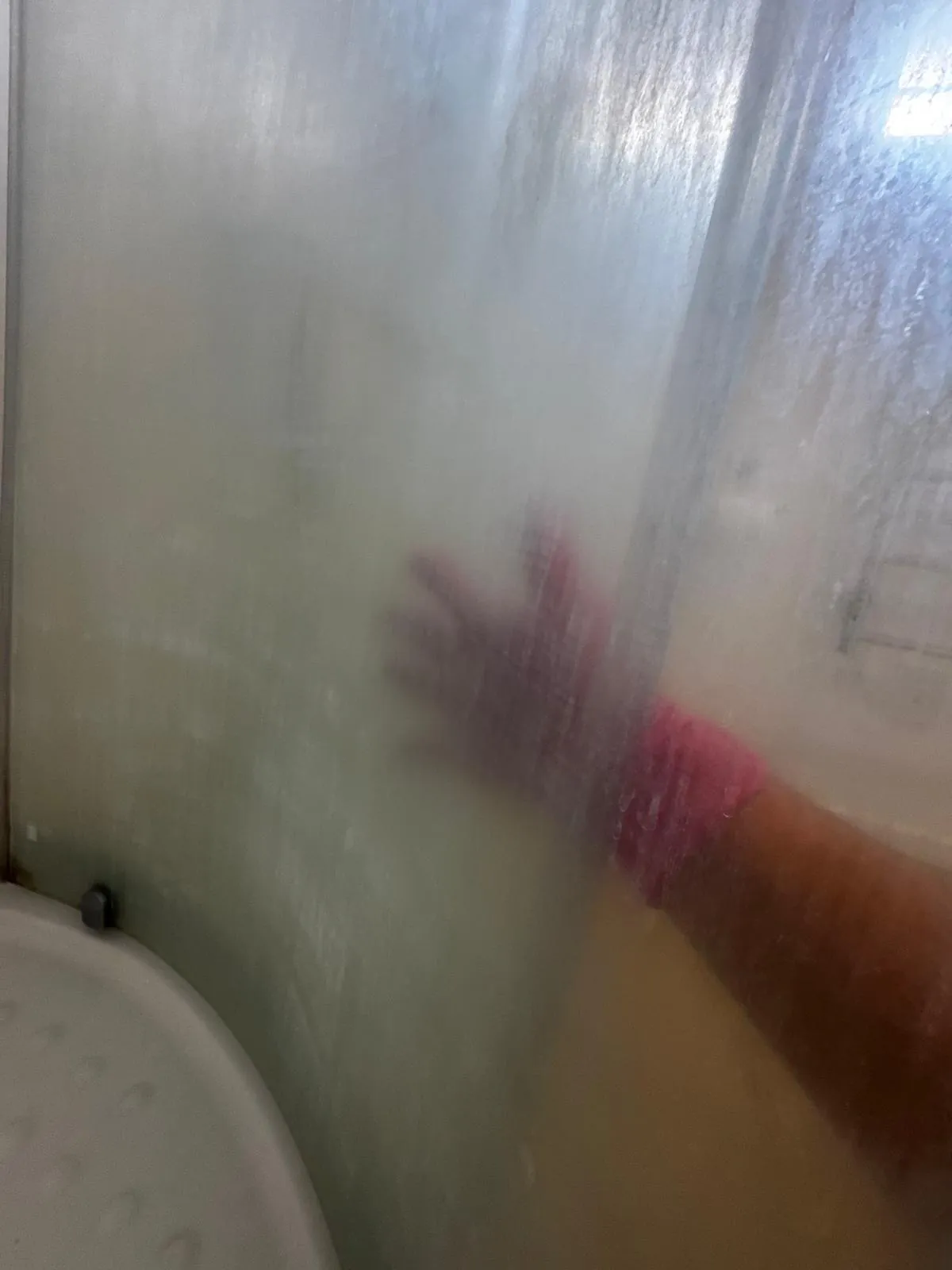 Bathroom cleaning before after Auckland — shower glass clouded with soap scum before cleaning